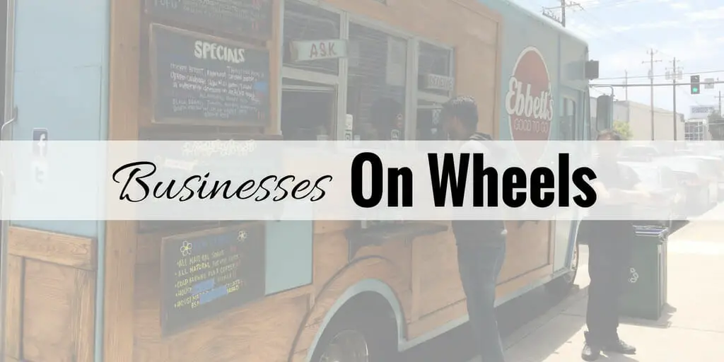 Food truck parked on side of the street during the day with one customer at the window and one customer waiting in line.